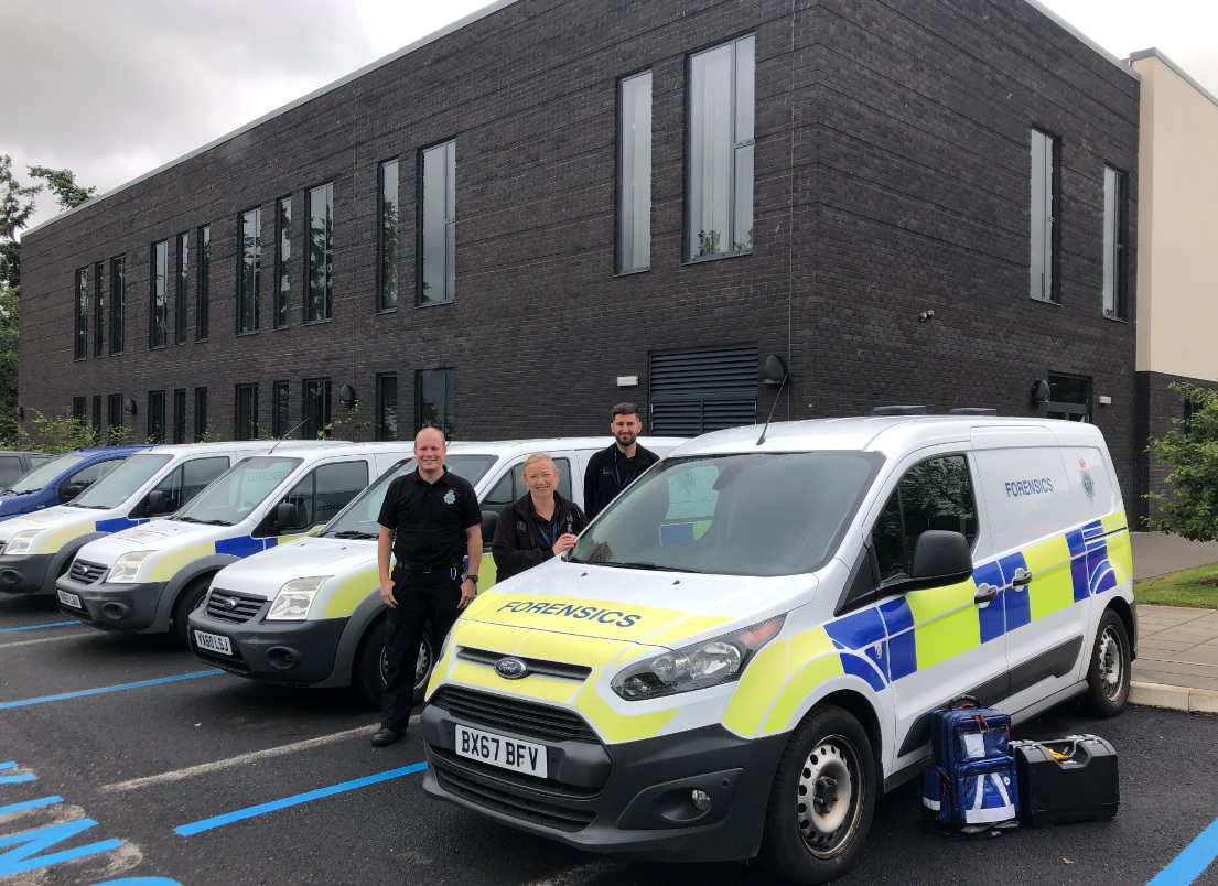 Members of the team with a forensics vehicle and kit