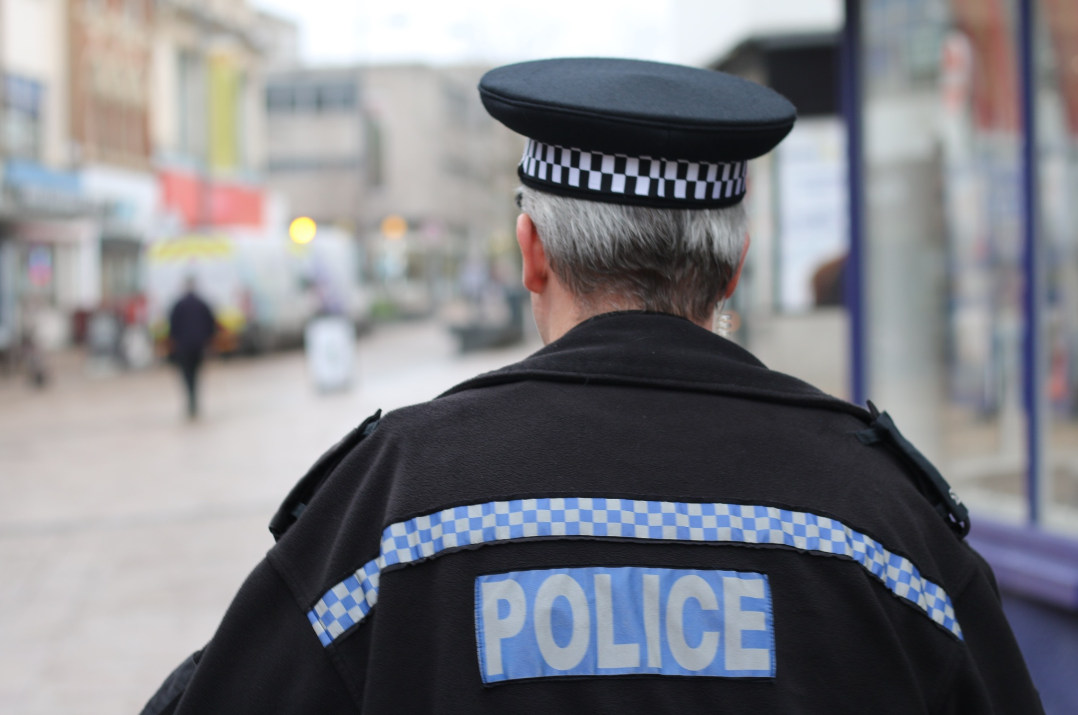 Picture showing the back of an officer out on patrol in a town centre (stock)
