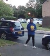 Image of woman wearing blue hoodie with yellow smiley face.