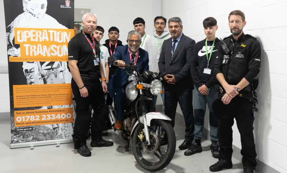 image of the bike being handed to the college