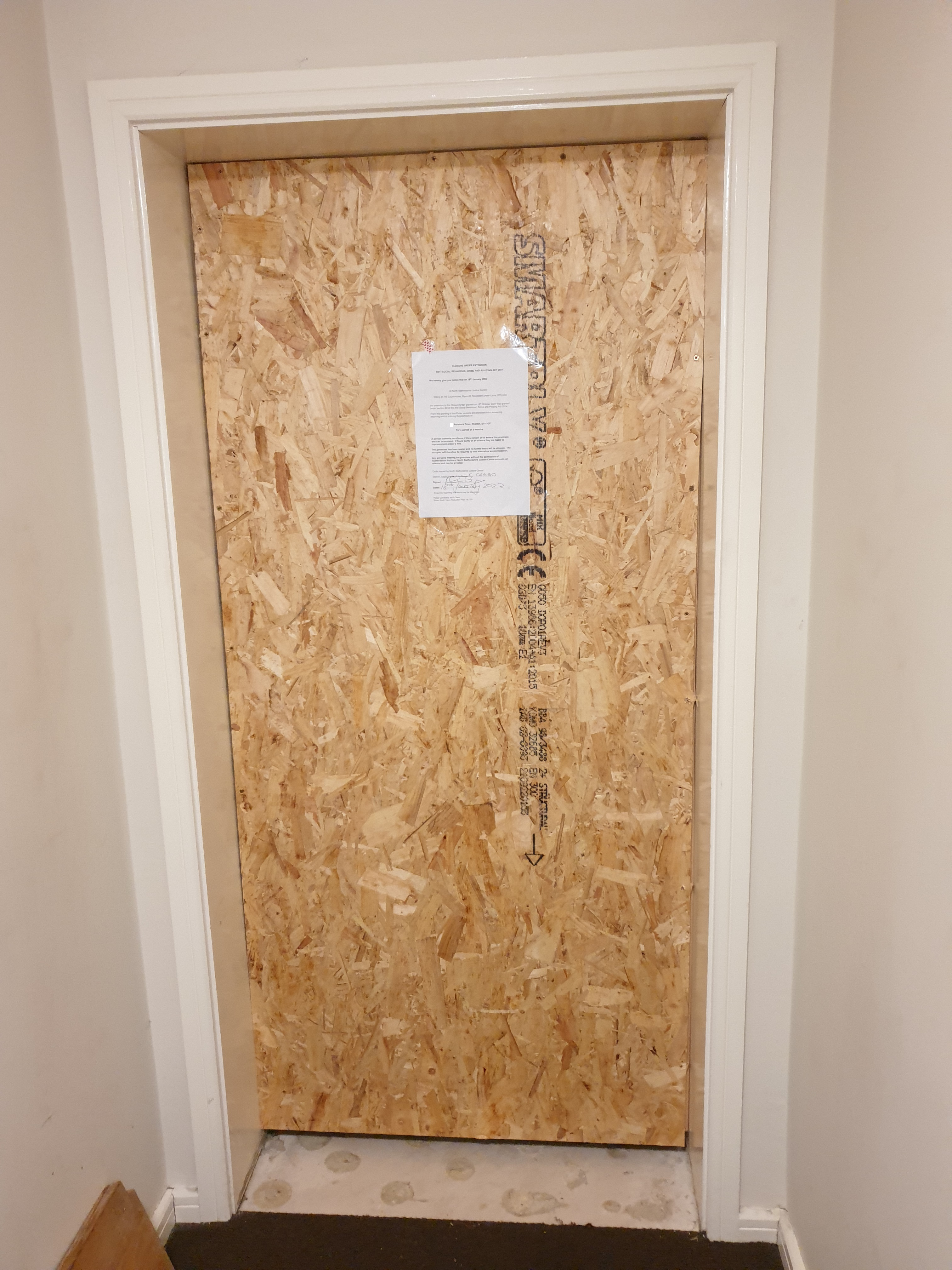 Shelton property, door boarded up